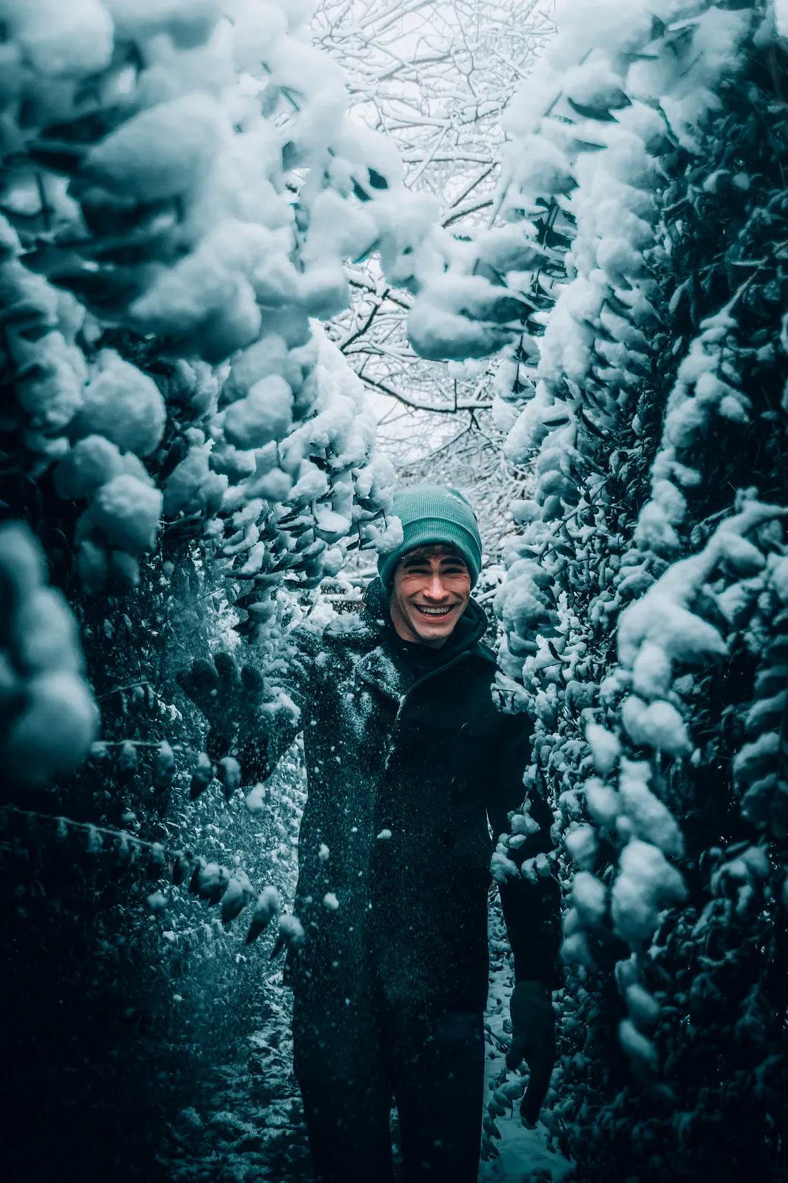 A man has fun in the moment playing in the snow.