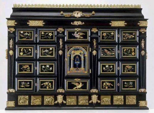 The cabinet was made in Florence. It is oak veneered in ebony and incorporates 19 (pietre dure), or hardstone, plaques supplied by Domenico Benotti. The gilt-bronze mounts and plaques were added in England, in the workshop of Francesco Fanelli, though it is not known for certain when this took place. The gilt-bronze strawberry-leaf crest was probably made and added in about 1830–1840.