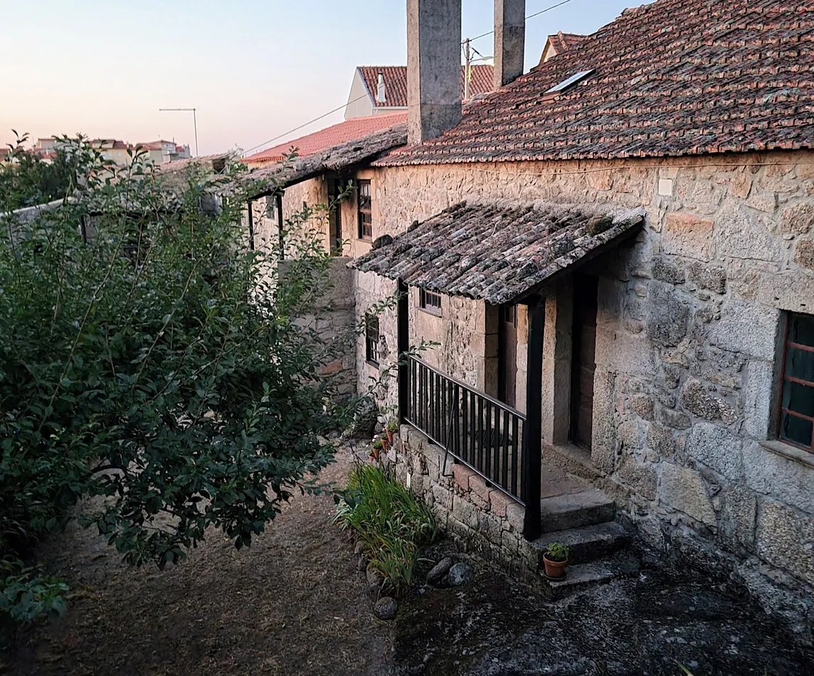 View of a stone farmhouse that has been separated into separate apartments.