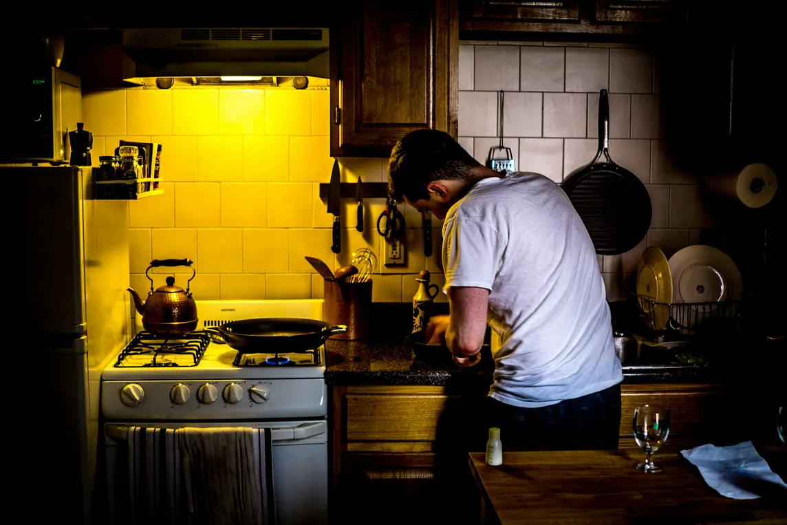 A man is engaged in cooking as a part of his responsibility.