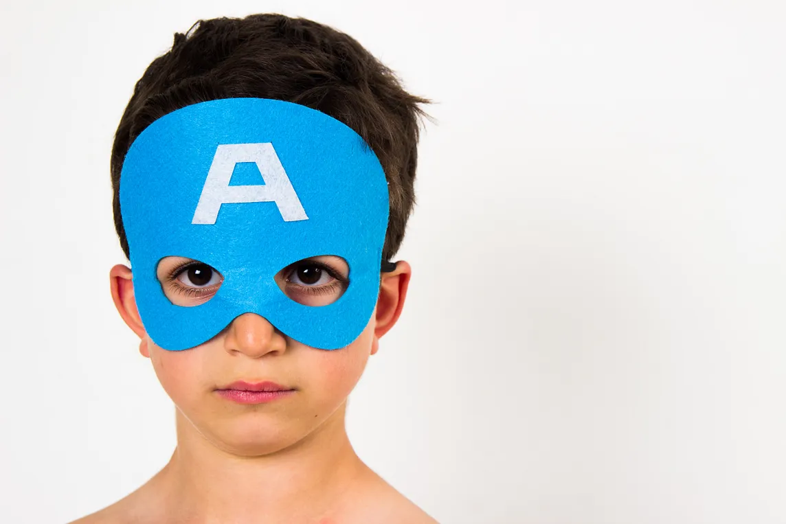 Boy wearing a mask and breakign free from the savior complex of trying to be a superhero