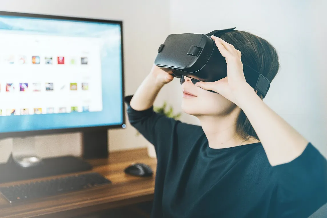 Woman wearing VR headset. Photo by JESHOOTS.COM on Unsplash