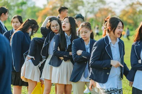 A group of school girls in school uniform.