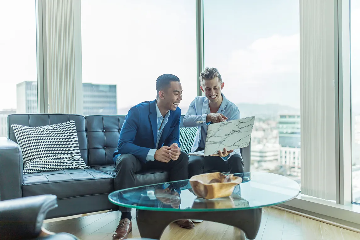 Two men on the couch discussing how to influence others without authority