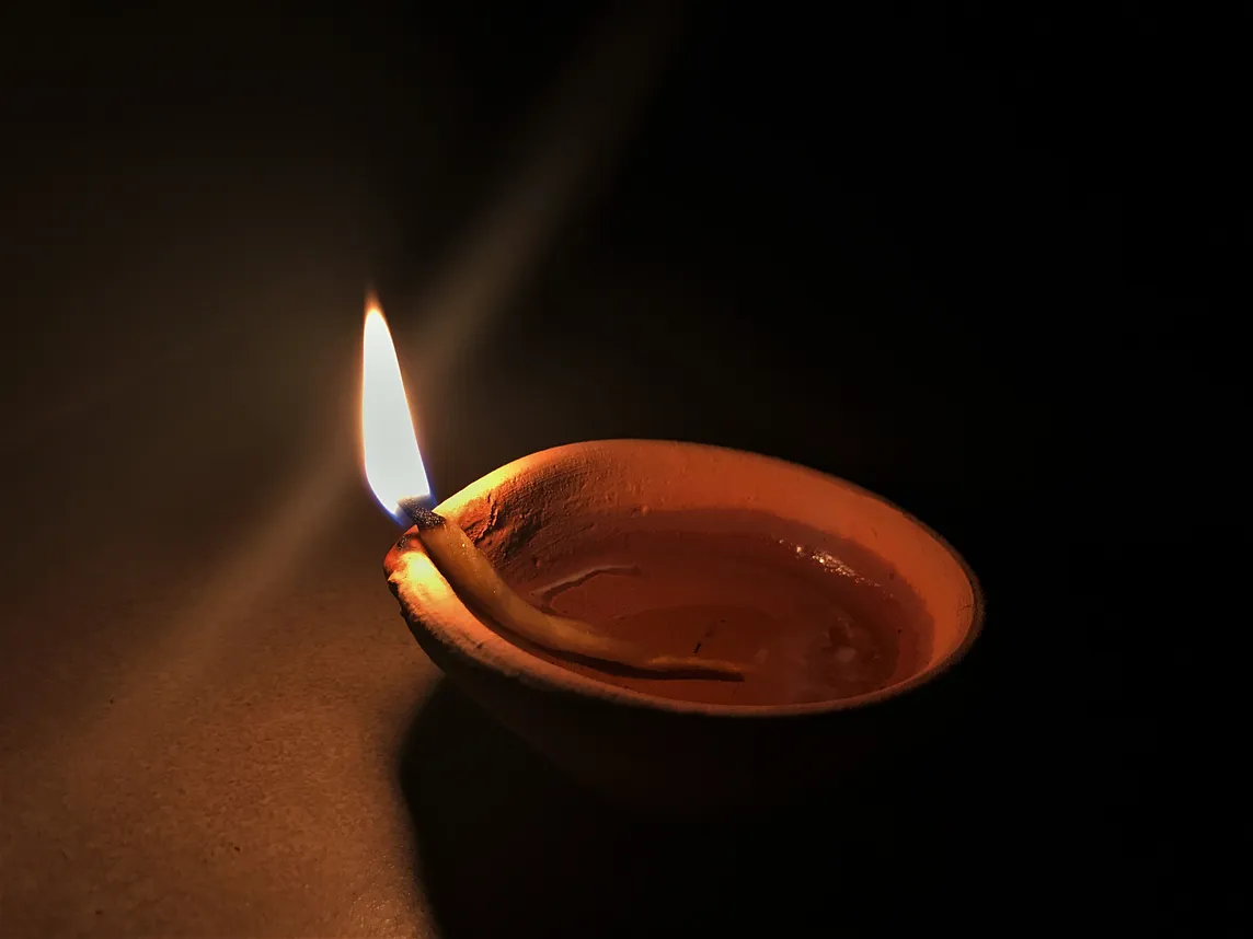 A lit diya ( lamp ).