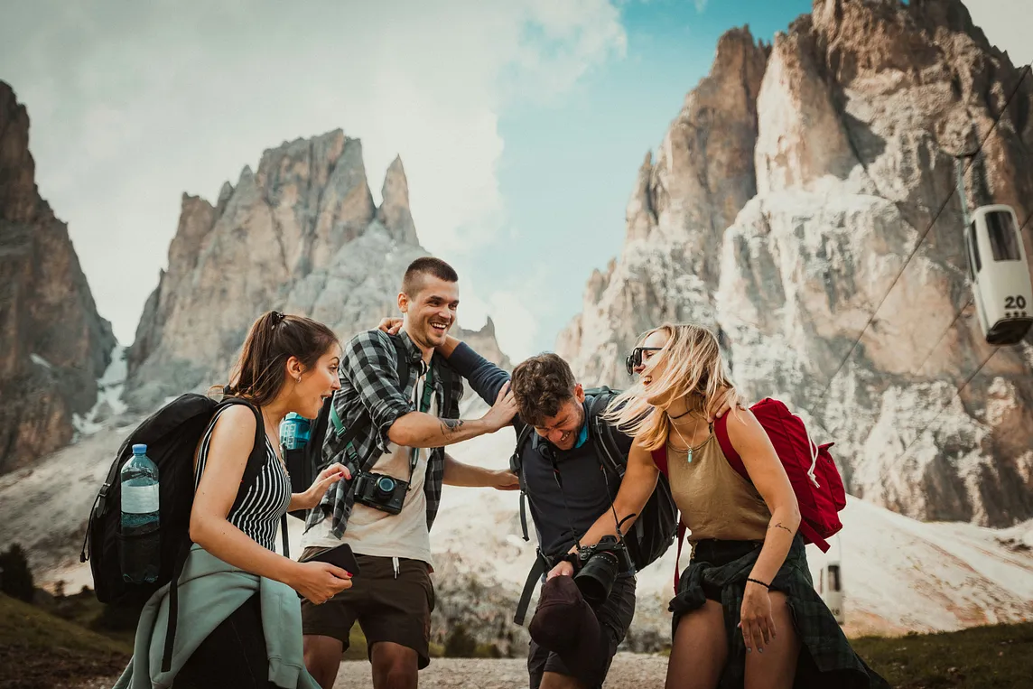 A group of friends against a backdrop of mountains