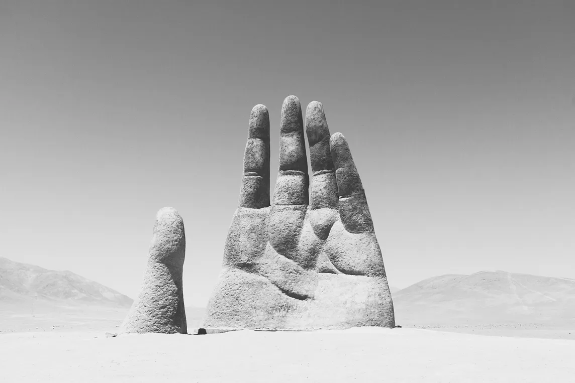 A statue of a hand in black and white