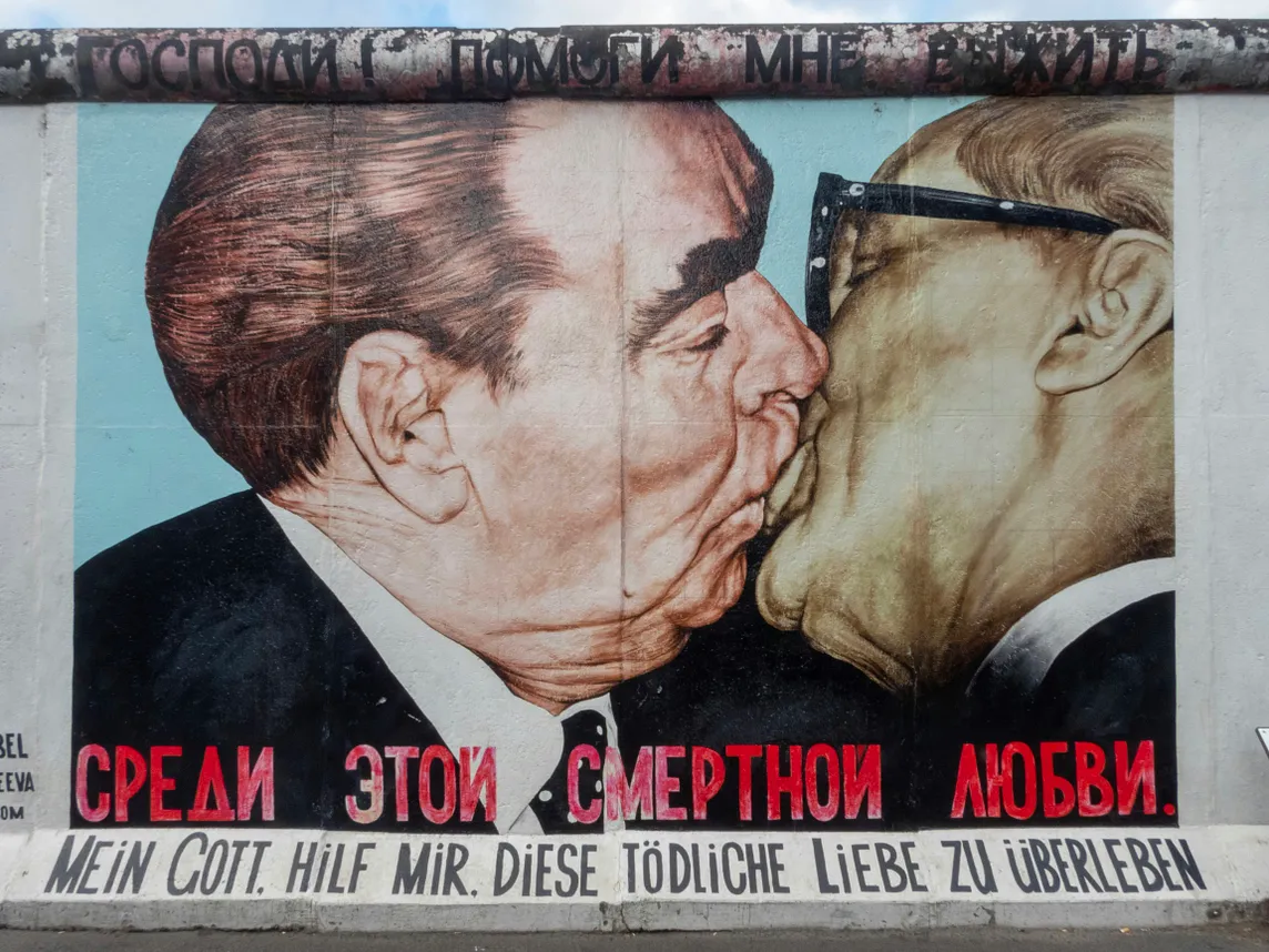 Breschnew and Honecker are kissing. Graffiti at the Berlin wall.