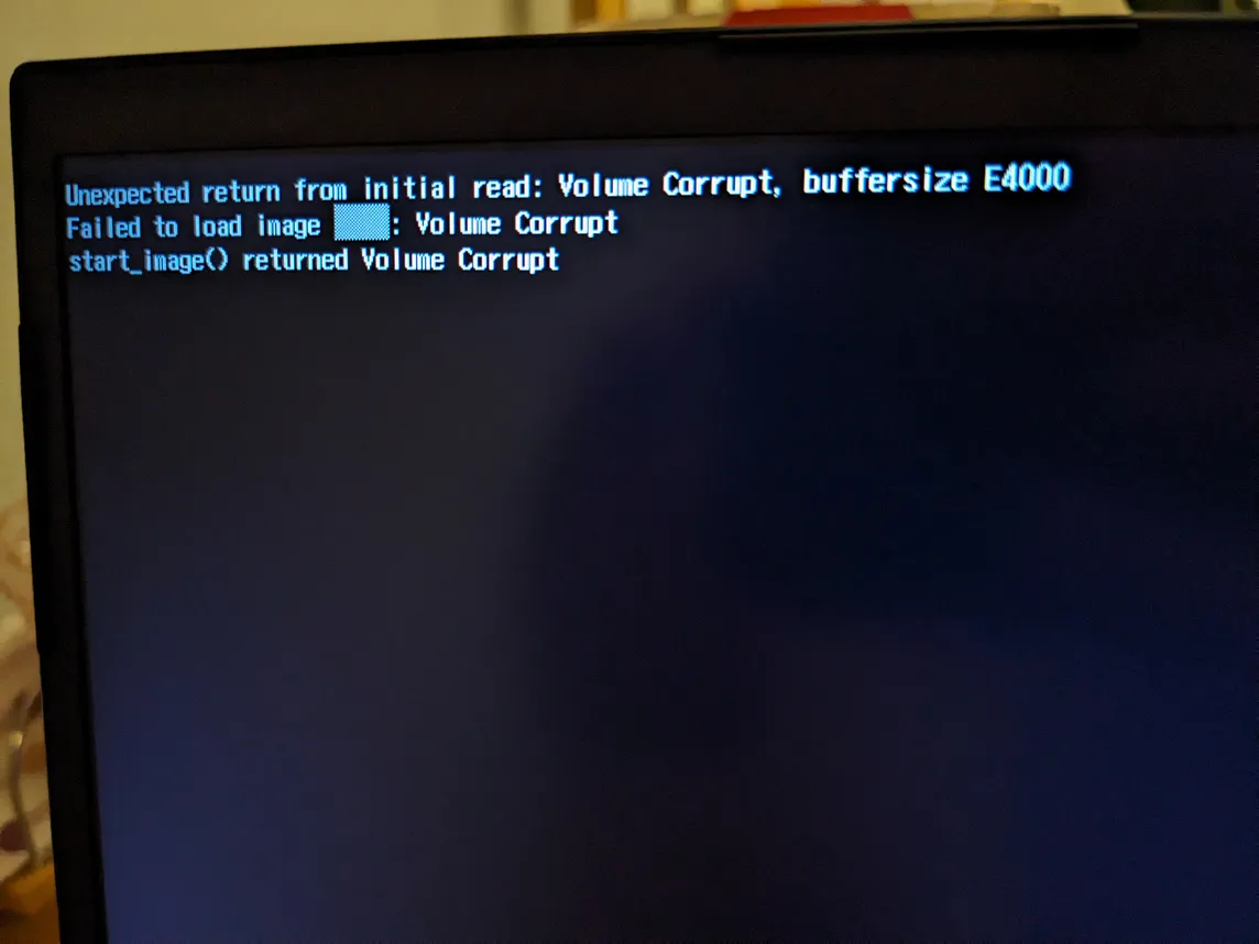 Photo of my laptop failing to boot, “failed to load image”, “Volume Corrupt”