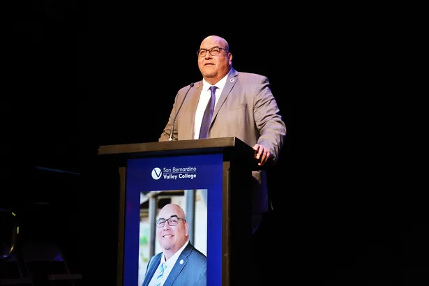 Dr. Contreras standing behind a podium speaking