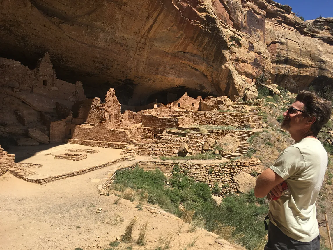 A man admires cliff dwellings in Colorado
