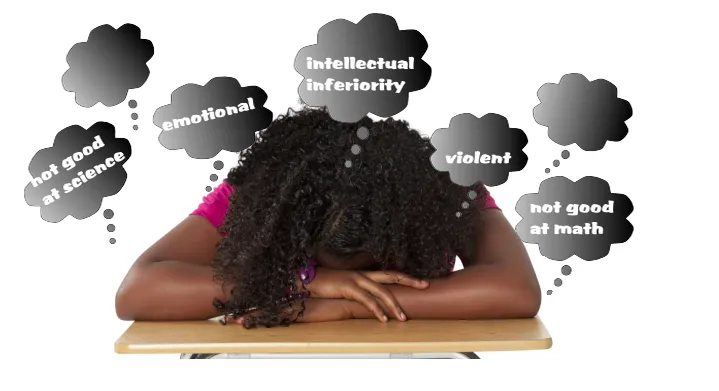 A student looking stressed by stereotypes while at her desk.