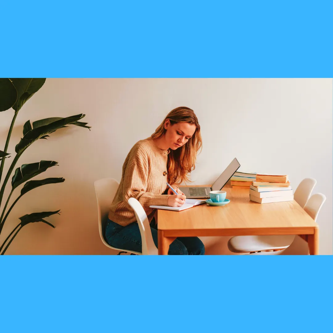 Woman at a desk with books and papers