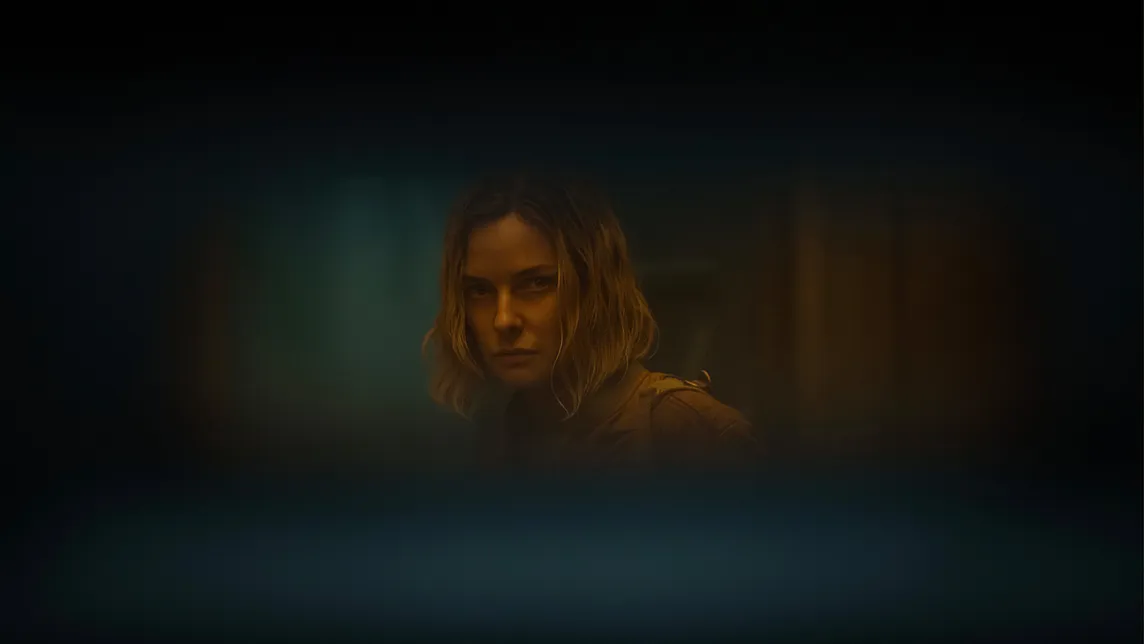 A still from the series showing Juliette through a door slit.