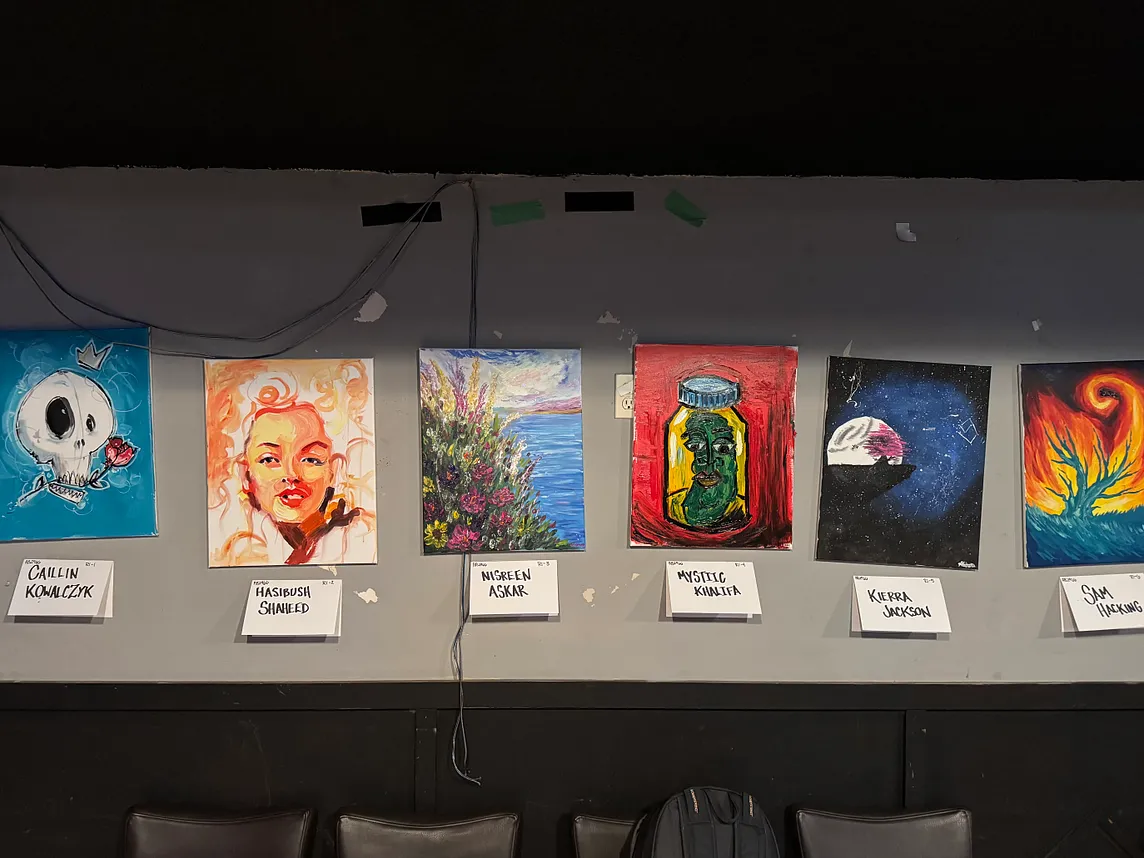 six paintings on display at an artbattle event