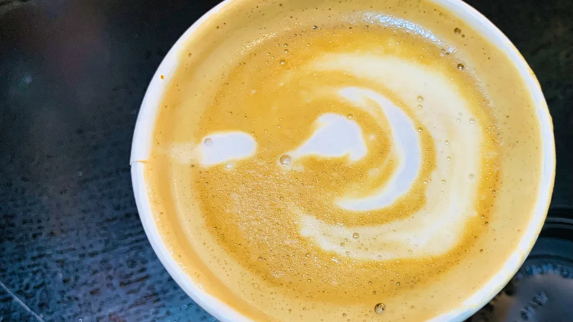 a beautiful art on top of a cup of coffee