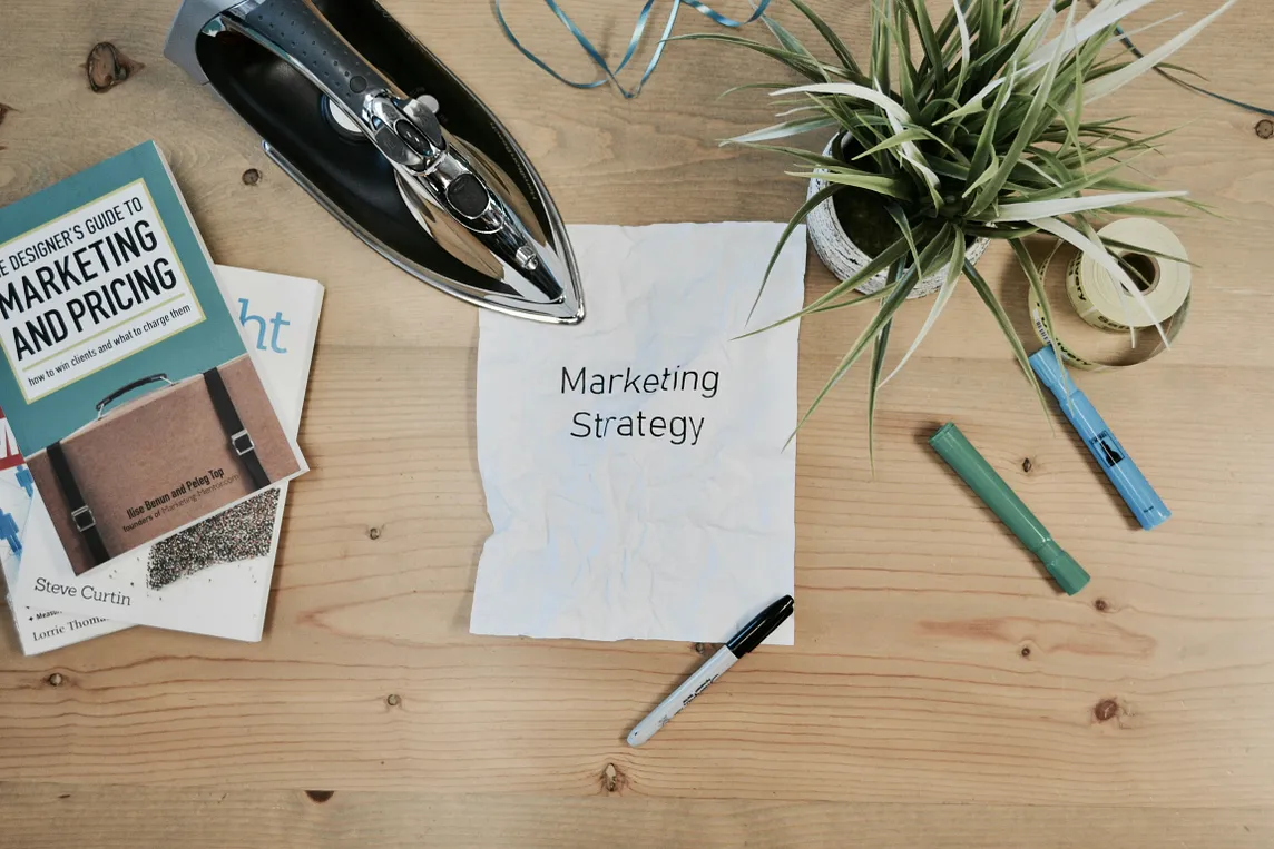 Wood table with marketing literature on it.