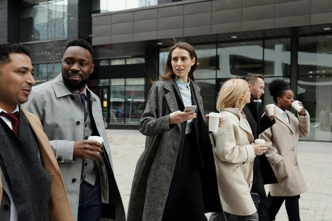 Team walking outside with purpose after deciding to stop planning and take action | Image by August de Richelieu on Pexels