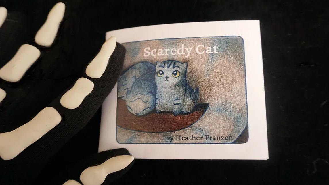 photograph of the front cover of a tiny book: Scaredy Cat by Heather Franzen