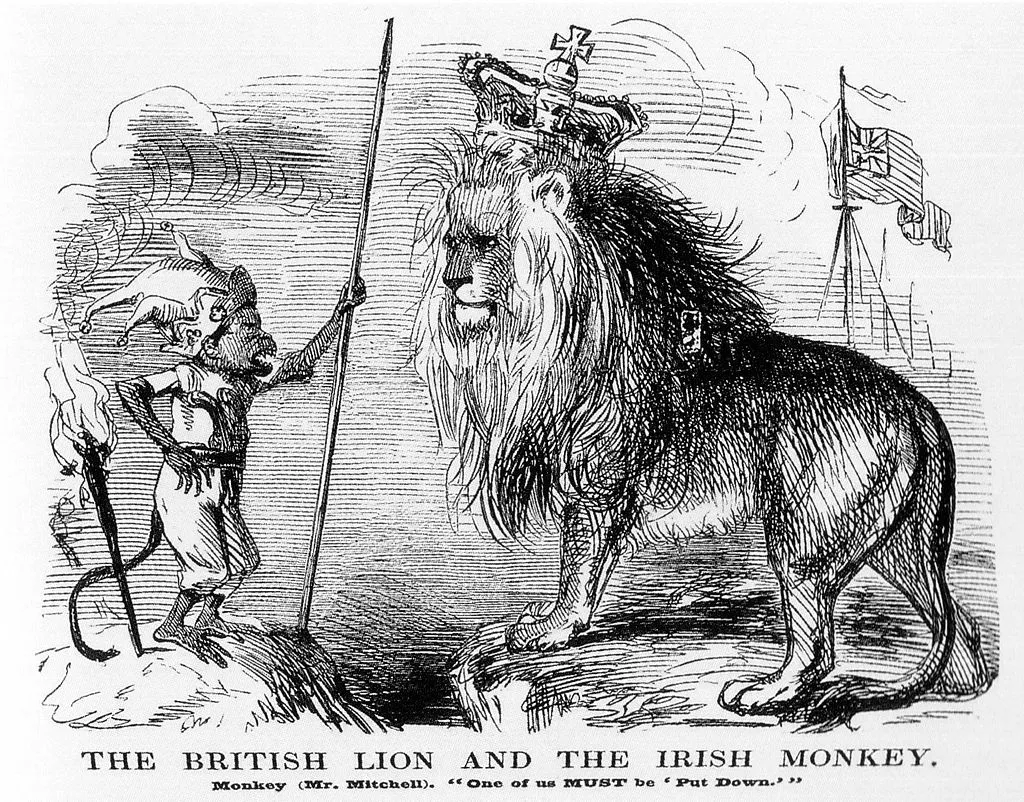 Cartoon captioned ‘The British Lion and the Irish Monkey’. Black and white drawing of a monkey wearing a jester’s hat and holding a speer (left) screeching at a large lion wearing a royal crown (right), with flags in the background.