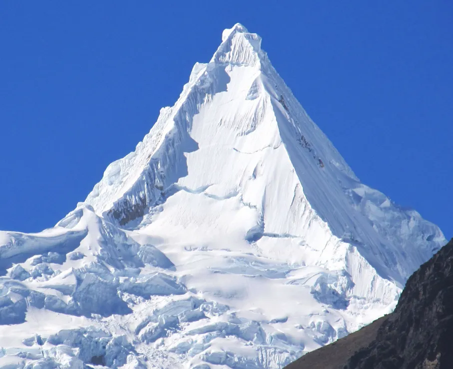 Mt. Alpamayo, Peru (19,511 ft, 5,947 m). Photo by Frank R 1981, on Wikipedia.