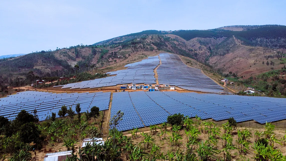 A large solar plant with thousands of panels installed on a hill.