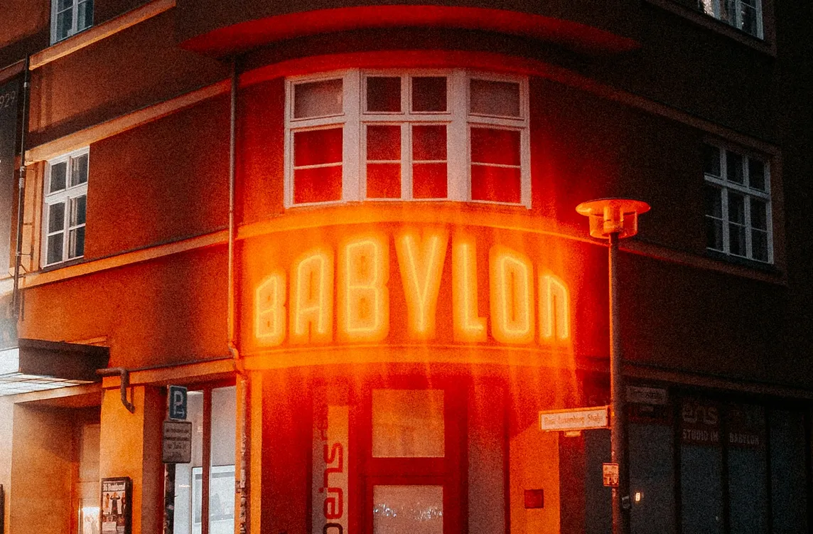 A building with a lighted sign reading “Babylon”