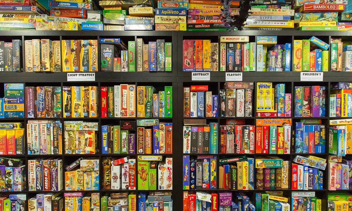A wall of shelves filled with colorful board games