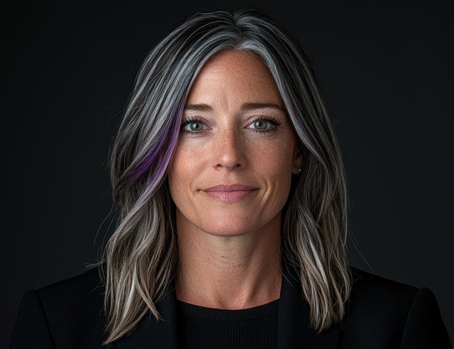 Laura Wells, wife of Joshua, attractive white woman, early 40s, hair greying, one lock of purple hair