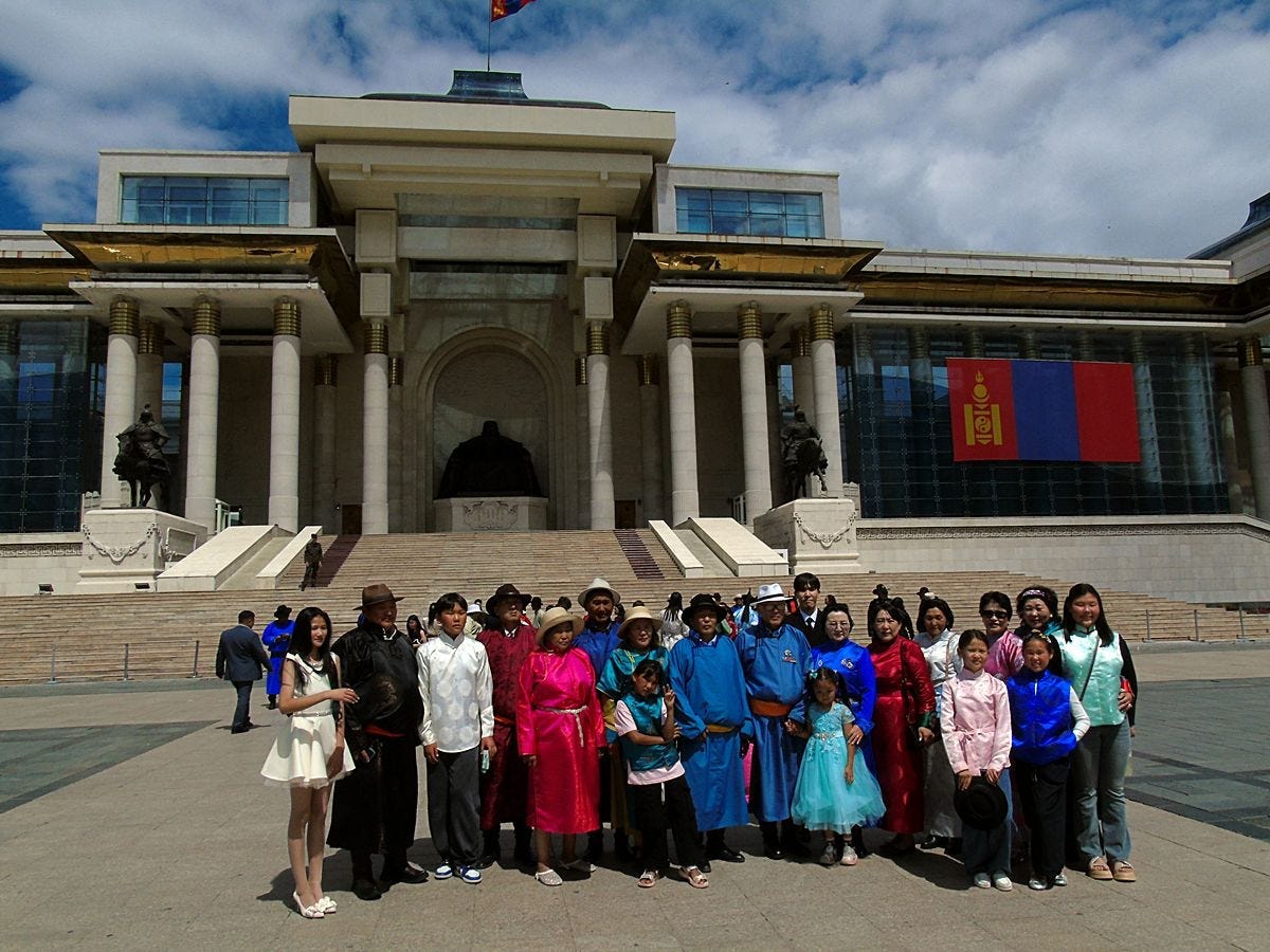 A family gathering in Sükhbaatar Square, where everyday life unfolds beneath Mongolia’s national symbols