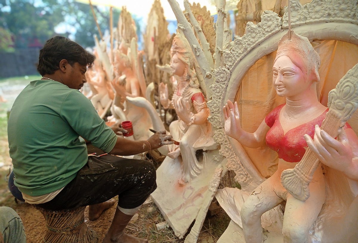Sculptor painting the Saraswati statue made of clay at Inaruwa in