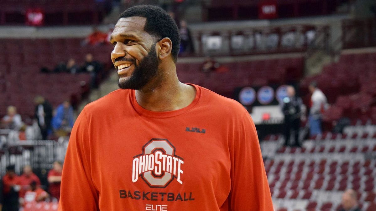 Ohio State's Greg Oden reacts to the crowd before an interview