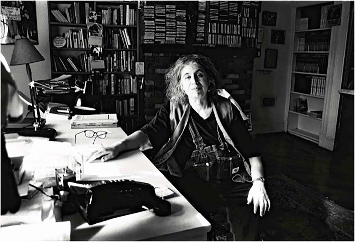The radical feminist author Andrea Dworkin seated at her desk in her booklined study in Brooklyn, October 2003.