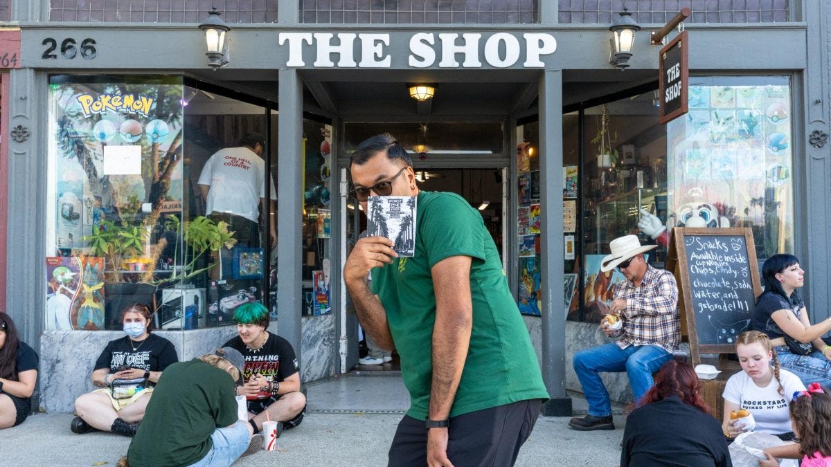 Anthony Solorzano stands outside The Shop in downtown Pomona, holding a copy of his zine “Worst Zine Ever” during its launch party. (Kevin Saporsantos)