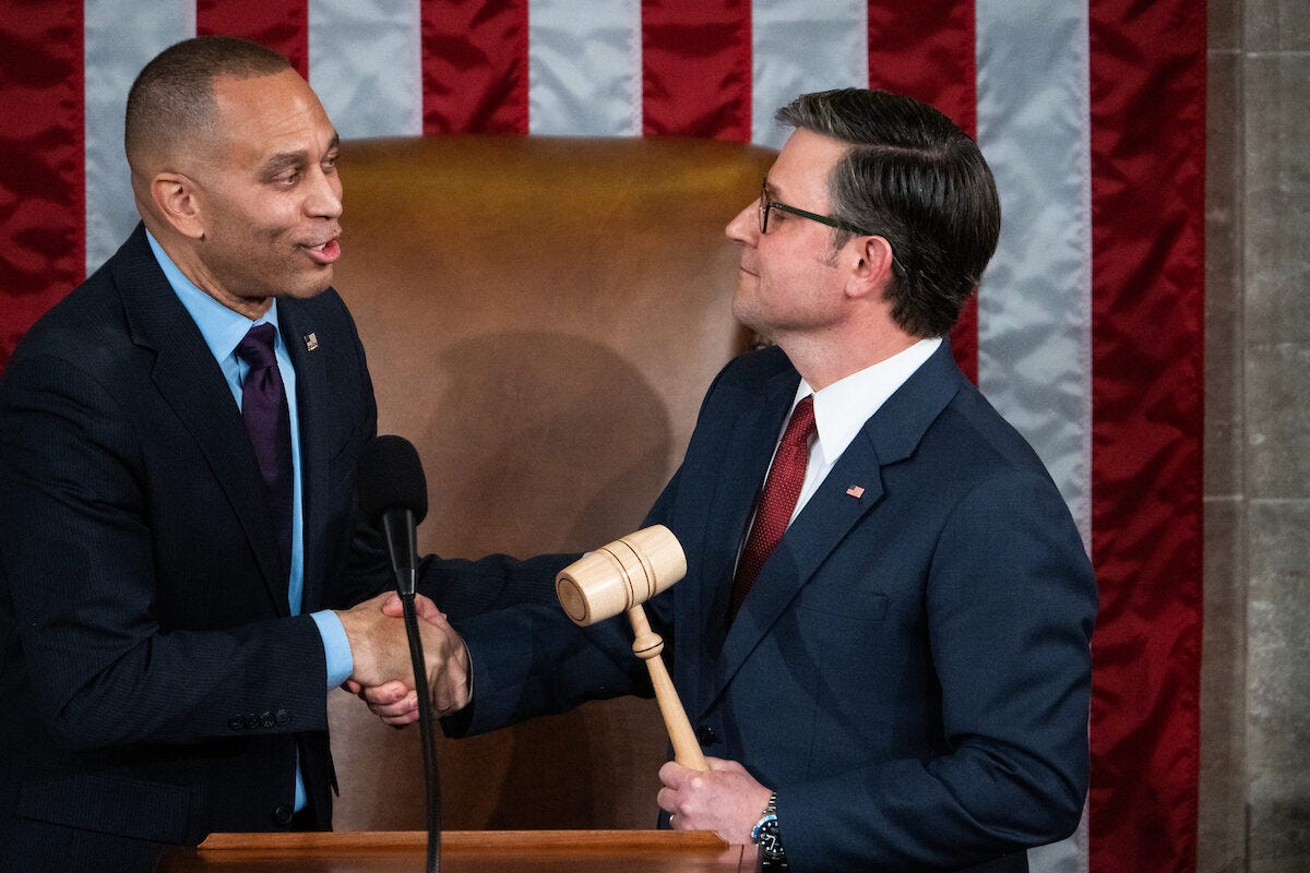 House Speaker Mike Johnson (R-LA-04) and House Democratic Leader Hakeem Jeffries (D-NY-08) shaking hands.