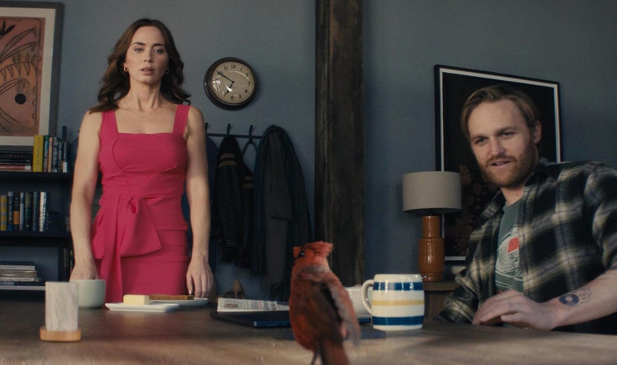 Margaret listens to a message. Wyatt finds it weird a bird is on his table. Image credit Universal Pictures