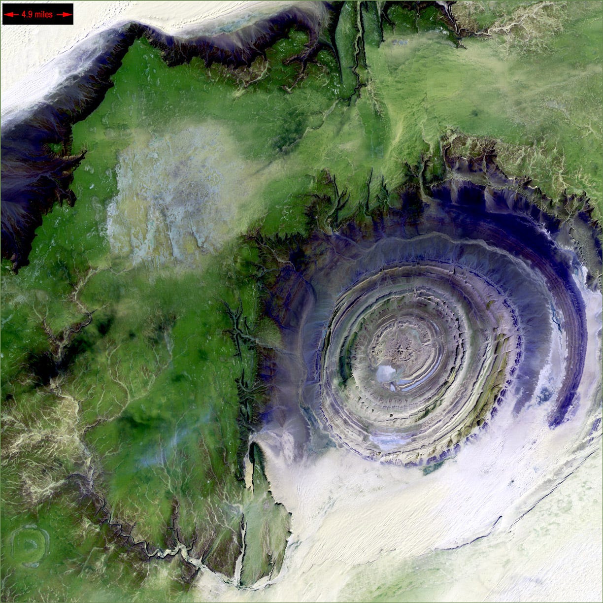 Satellite imagery shows the scale of the Richat Structure. At nearly 50 kilometers across, it is much larger than a normal city, which is one reason the Atlantis comparison remains controversial.. Credit: Landsat 7, USGS, NASA
