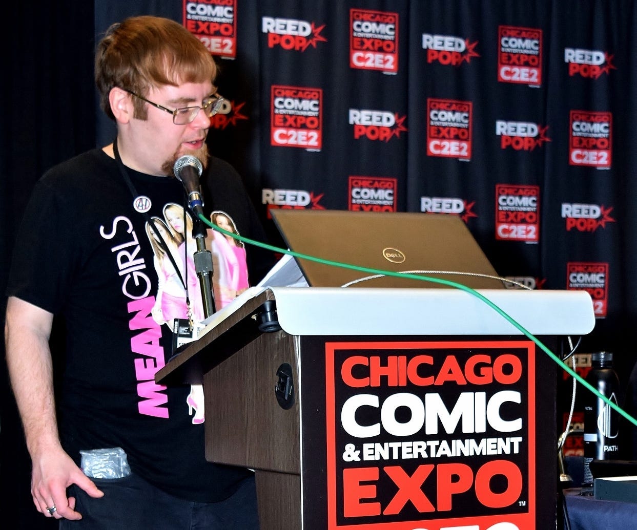 Nick Ulanowski (me) hosting and moderating the ‘Why Comic Book Crowdfunding?’ panel at C2E2, sporting an anti-AI button. (Photo by Nick Maro)