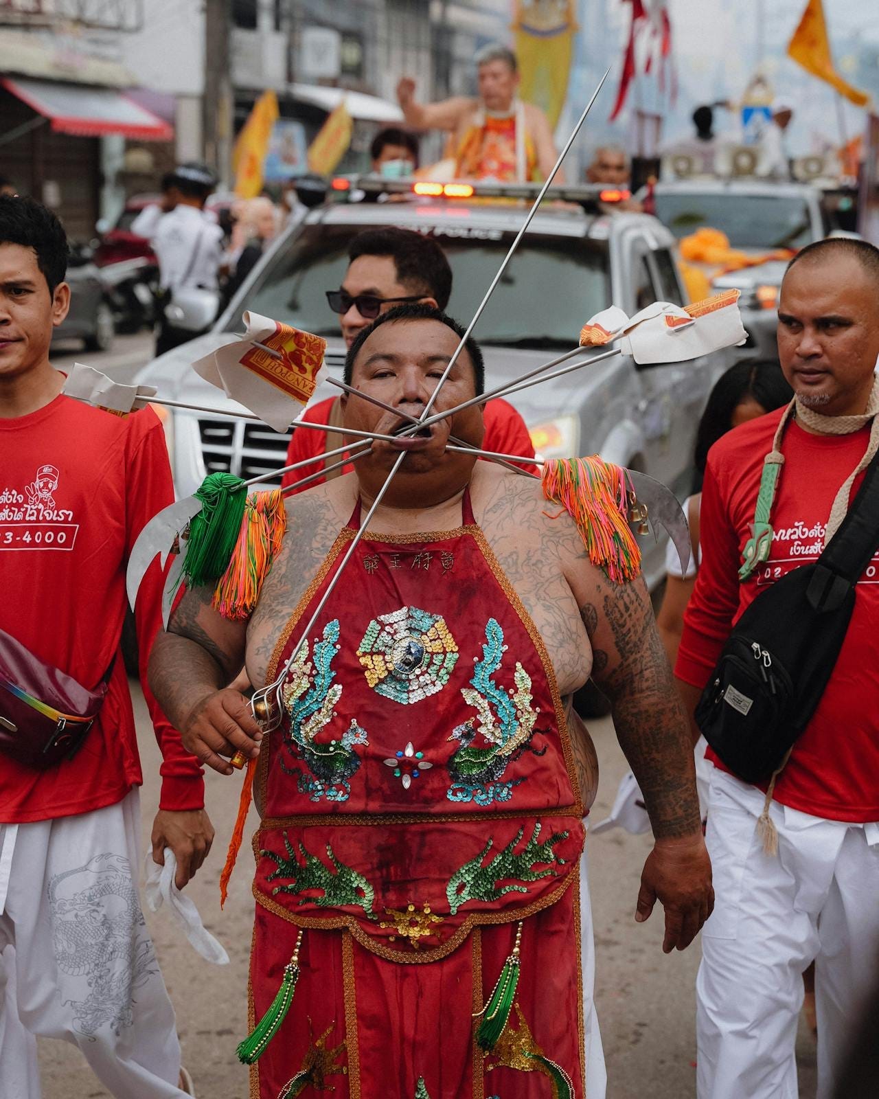 A devotee parades down the streets of Phuket with skewers through his mouth. Photo by Maksim Romashkin via Pexels.