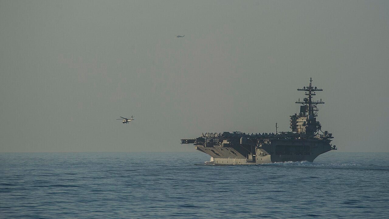 STRAIT OF HORMUZ (June 14, 2014) The aircraft carrier USS George H.W. Bush (CVN 77) transits the Strait of Hormuz with the Arleigh Burke-class guided-missile destroyer USS Truxtun (DDG 103).