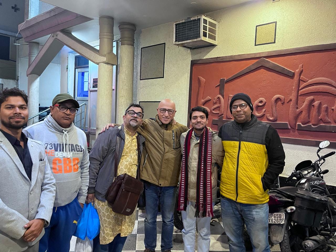 Prof. Chawky Frenn with friends, city cultural workers, and students of Banaras Hindu University (BHU) during a celebratory dinner at Kamesh Hut Hotel, Varanasi, marking a warm city welcome following the Jan Mitra Samman ceremony.
