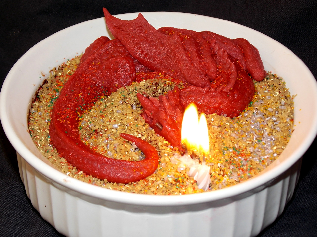 Marzipan Smaug atop a treasure of golden sprinkles and rich chocolate souffle.