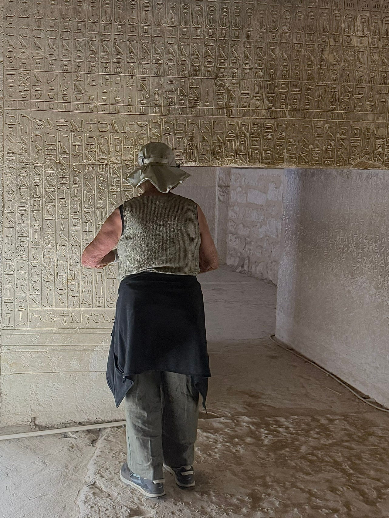 Left: Collonade entrance to the Djoser step pyramid complex. Right: Reading hieroglyphic text in the Teti Pyramid undeground tomb. Photo: David A. Laws