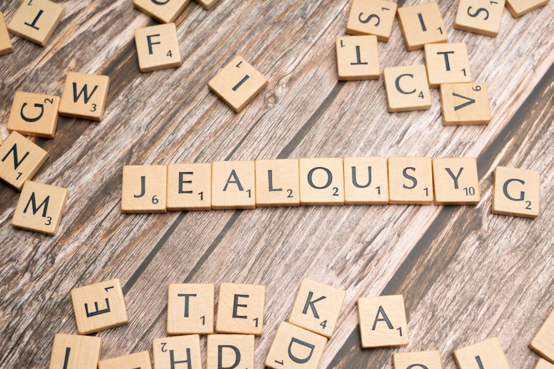 Scrabble blocks forming the word ‘jealousy.’