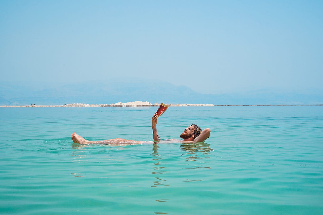 A man floating in the buoyant waters of the Dead Sea