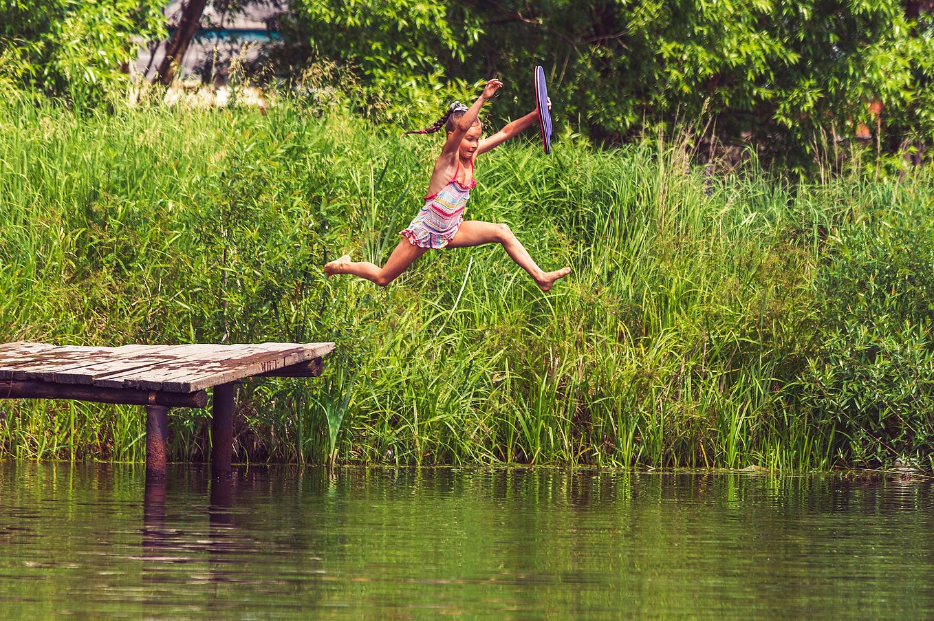 Enjoying summer fun by jumping into the river.