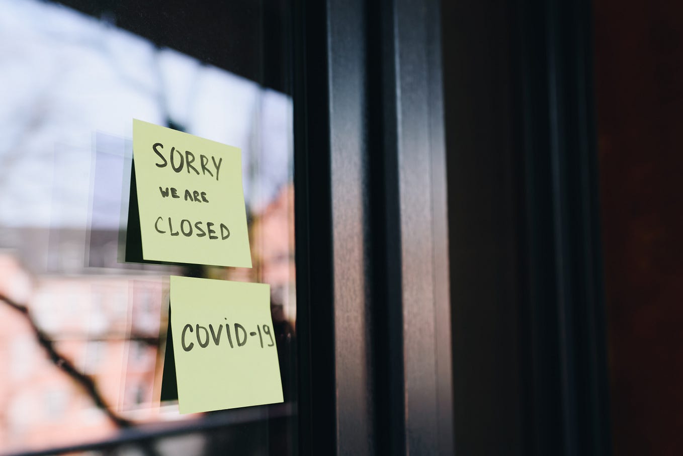 Sign on business door: Sorry we are closed, COVID-19