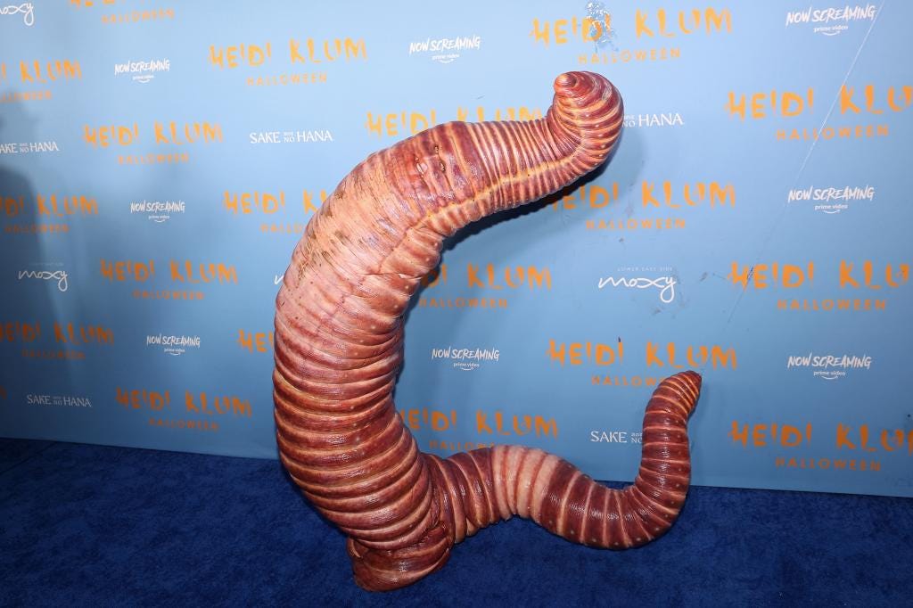 Heidi Klum Pitching Her Incredible, Preternatural, Ascendent Worm Costume  to the Design Team, by T. L. Pavlich
