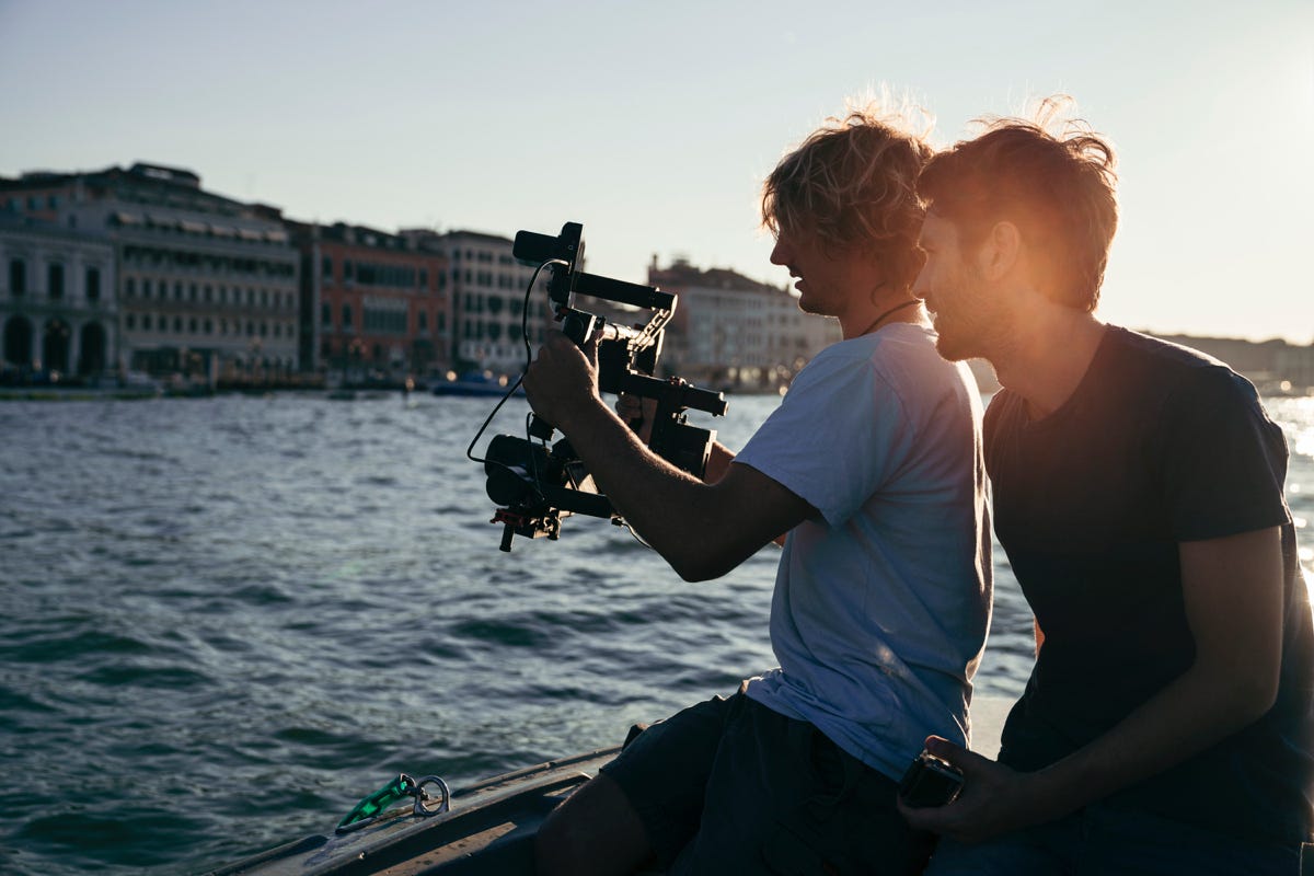 Young Videographer Shooting On The Beach Using He Looking, 43% OFF