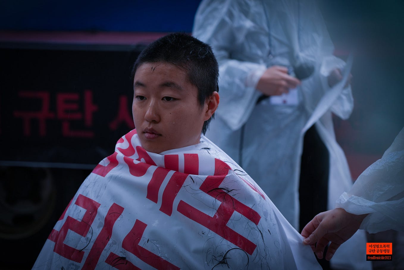 A South Korean woman shaving her hair in a protest